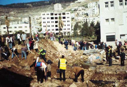Palestinians and internationals removing the roadblock at the Makatah in January 2003.